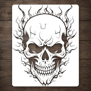 May include: A rectangular stencil featuring a black line art illustration of a human skull surrounded by stylized flames. The design is centered on a white background, showcasing detailed shading lines within the cranium and jaw area.