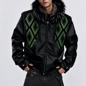 May include: A black faux leather jacket featuring a green diamond-patterned textured panel on the chest and a dark faux fur-lined hood. The jacket has a front zip closure, long sleeves with buttoned cuffs, and a structured, slightly oversized fit.