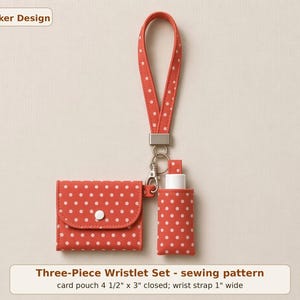 May include: A coral-colored wristlet set with white polka dots, featuring a card pouch measuring 4.5 inches by 3 inches, a 1-inch wide wrist strap, and a small bottle holder. The set is labeled Walker Design and Three-Piece Wristlet Set.