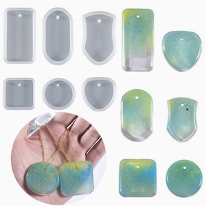 May include: A collection of silicone moulds in various geometric shapes including rectangles, circles, and shields, alongside finished resin pendants featuring a blue and yellow gradient with glitter, each with a small hole for hanging on a chain.