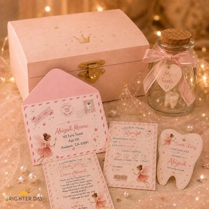 May include: A light pink wooden keepsake box with a gold latch, a glass jar with a cork lid containing a tooth and a pink ribbon tag labeled My Tooth, a pink envelope addressed to Abigail Moore, a Tooth Fairy receipt, and a tooth-shaped certificate.