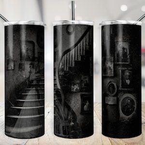 May include: Three black stainless steel tumblers with a spooky, vintage-inspired design. Each tumbler features a black and white image of a staircase with framed portraits on the walls.