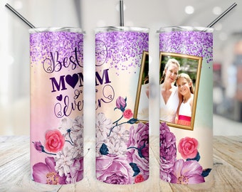 May include: A purple and pink glitter tumbler with a floral design and the text "Best Mom Ever". A photo of a mother and daughter is in a gold frame on the tumbler.