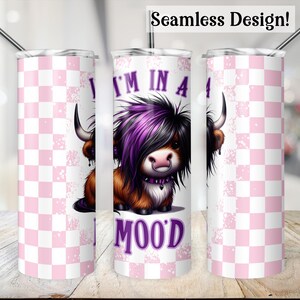 May include: A pink and white checkered tumbler with a cartoon image of a cow with purple hair and the text "I'm in a mood".
