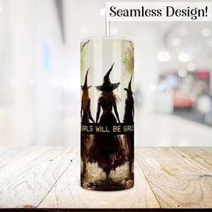 May include: A white tumbler with a design of three witches in black silhouettes walking together. The witches are wearing pointed hats and long robes. The text "Girls Will Be Girls" is printed on the tumbler.