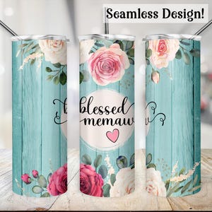 May include: A turquoise blue and white tumbler with a floral design and the text "blessed memaw" in a white circle with a pink heart.