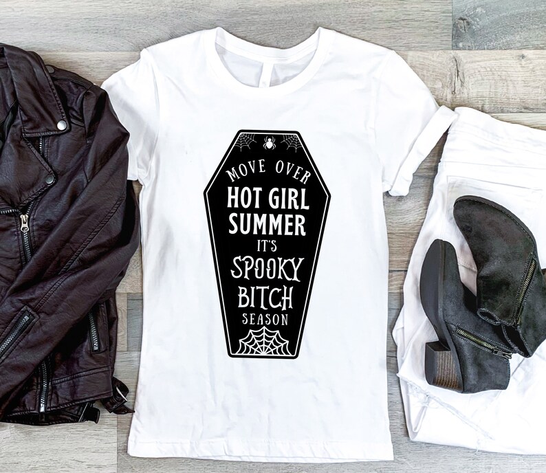 May include: White t-shirt with a black graphic of a coffin that says "Move Over Hot Girl Summer It's Spooky Bitch Season".