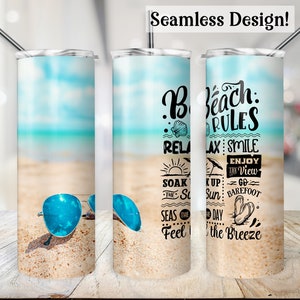 May include: A stainless steel tumbler with a beach-themed design. The tumbler features a beach scene with blue sunglasses on the sand and the text "Beach Rules". The background shows a blue sky and ocean. Includes a silver straw.