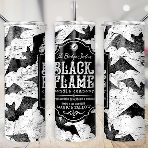 May include: Black and white tumbler with a distressed background pattern of bats. The tumbler has a black label with white text that reads "The Bishop Sisters Black Flame Candle Company Specializing in Candles & Curses Made with Genuine Magic & Tallow".