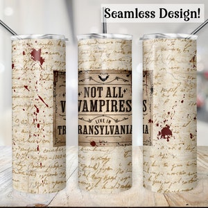 May include: A stainless steel tumbler with a white background and a vintage-style design. The tumbler features a brown rectangle with the text "Not All Vampires Live in Transylvania". The background is covered in handwritten text and red splatters.