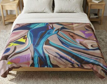 May include: A bed comforter featuring an abstract design with flowing shapes in shades of blue, brown, tan, purple, and yellow. The comforter covers a bed with white pillows and a white sheet, resting on a wooden bed frame in a bedroom setting.