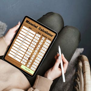 May include: A tablet displaying a digital Material Calculator spreadsheet with columns for Item, Price, Quantity, and Cost, featuring a wood-grain background, white input fields, and a light green Total Cost button at the bottom of the screen.