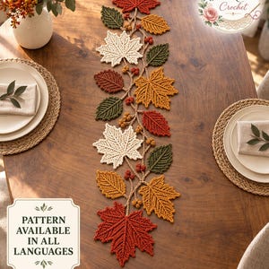 May include: A crochet table runner featuring a vine-like structure adorned with various autumn-colored leaves in shades of red, orange, yellow, and green, along with small berries. The text "BloomRunner Crochet" and "PATTERN AVAILABLE IN ALL LANGUAGES" appear.
