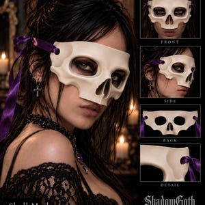 May include: A cream-colored skull mask featuring eye and nose cutouts, secured with purple satin ribbons. The mask is displayed in multiple views including front, side, back, and a close-up detail. The text ShadowGoth RELICS is visible.