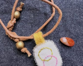 Collana con ciondolo in fibra cucita a mano, amuleto