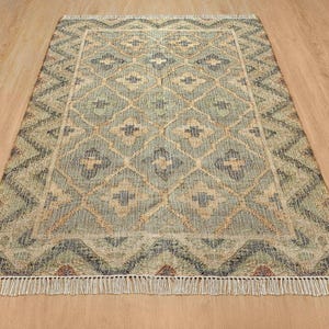 Detailed view of the faded slate blue cross motifs and dusty seafoam borders, proving this bespoke piece is a far better investment for modern spaces than chaotic fun rugs and a funky rug, effortlessly capturing quiet luxury over a busy chinoiserie rug.
