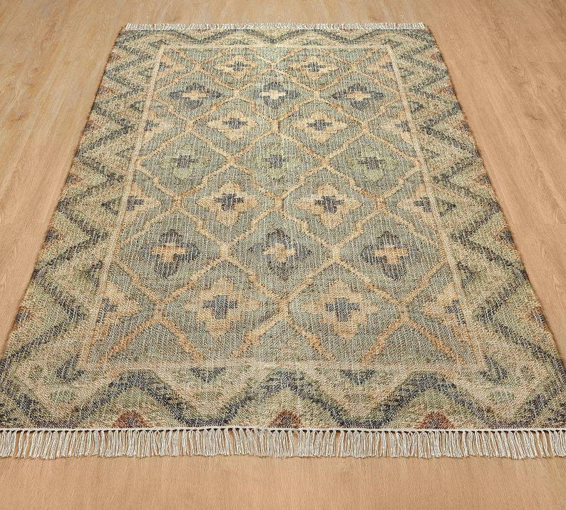 Detailed view of the faded slate blue cross motifs and dusty seafoam borders, proving this bespoke piece is a far better investment for modern spaces than chaotic fun rugs and a funky rug, effortlessly capturing quiet luxury over a busy chinoiserie rug.