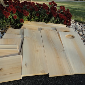 May include: A set of unfinished wooden boards, some with cutouts, ready for a DIY project.
