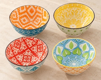 May include: A set of four ceramic bowls featuring distinct colorful patterns. One bowl has an orange geometric design, one has a yellow floral motif, one has a red intricate pattern, and one has a blue and green leaf-like design.