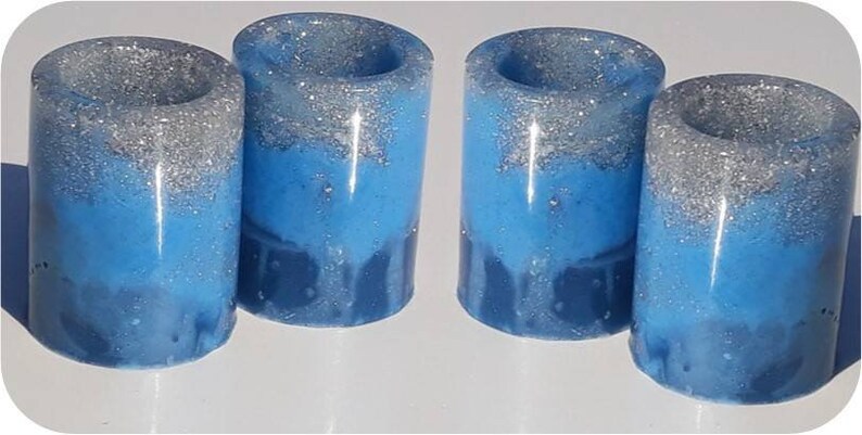 Four two-tone blue with silver shot glasses. coaster also available .