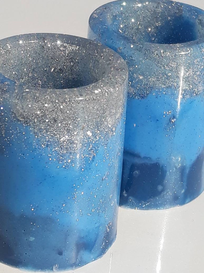 Four two-tone blue with silver shot glasses. coaster also available .