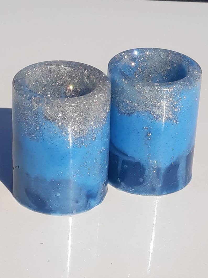 Four two-tone blue with silver shot glasses. coaster also available .