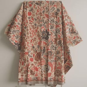 May include: A rectangular textile featuring a dense, intricate pattern of stylized flowers, leaves, and peacock motifs in shades of terracotta, dark brown, and cream. The fabric displays a repeating botanical design with a border along the bottom edge.