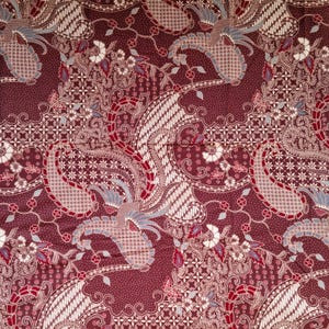 May include: A deep maroon fabric featuring a dense batik pattern with intricate white and light blue stylized bird motifs, swirling paisley shapes, and delicate floral elements. The design includes fine geometric lines and dotted textures.