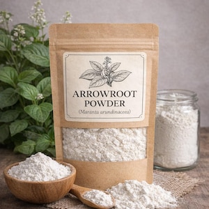 May include: A brown paper pouch of Arrowroot Powder with a clear window, labelled with the text LuvHerbs, Arrowroot Powder, and Maranta arundinacea. The pouch is accompanied by a small wooden bowl and spoon filled with white powder.