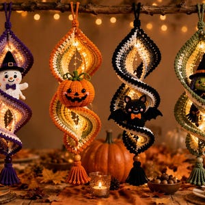 May include: Four hanging crochet spiral decorations featuring Halloween characters: a snowman in a witch hat, a jack-o'-lantern, a black bat, and a green-skinned witch. Each spiral is illuminated with warm string lights and finished with a tassel.