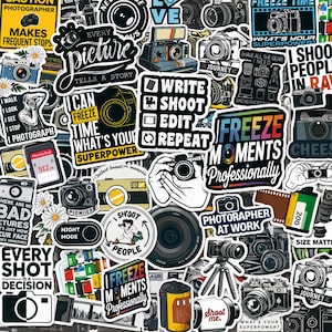 May include: A collection of photography-themed stickers featuring various cameras, film rolls, and text including "Every picture tells a story," "Write shoot edit repeat," "Freeze moments professionally," and "Every shot is a decision."