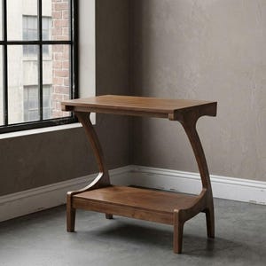 May include: A brown wooden side table featuring a rectangular top surface and a lower shelf. The table is supported by two curved, Z-shaped side panels that connect the top and bottom sections, creating a distinct profile with four short legs.