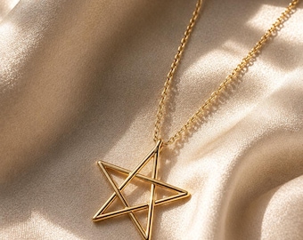 May include: A gold-toned necklace featuring a five-pointed star pendant suspended from a delicate chain. The star is constructed from thin, smooth metal bars forming an open geometric shape. The logo for Contemporary Jewellery is visible.