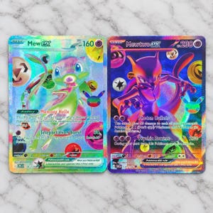 May include: Two holographic Pokemon trading cards side by side. The left card features Mew ex with 160 HP, Memory Helix ability, and Teleportation Burst attack. The right card features Mewtwo ex with 230 HP, Photon Bullets, and Psychic Powers attacks.