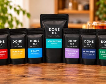 May include: A collection of nine black stand-up pouches of Done Tea, each featuring a unique colored label with specific flavor names like Get On With It, Warm Apple Pie, Done Posh, Chill Out, Done Gestion, Done For The Day, Proper Brew, Done Fresh, and I'm Done With Caffeine.