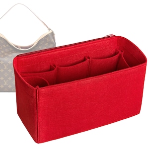 May include: A vibrant red felt handbag organiser with several compartments and a zipped top. The organiser is designed to fit inside a larger handbag, with a brown and tan handbag visible in the background.