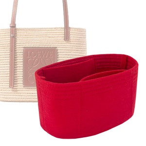 May include: Red felt bag insert with multiple compartments for organizing a straw tote bag.
