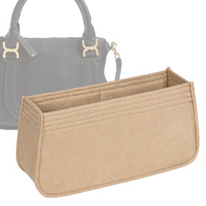 May include: Beige felt bag insert with multiple compartments for organizing a handbag. The insert has a rectangular shape and is designed to fit inside a larger bag.