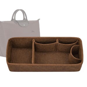 May include: A brown felt handbag organizer with multiple compartments and pockets. The organizer is designed to fit inside a tote bag, with a light gray tote bag in the background.