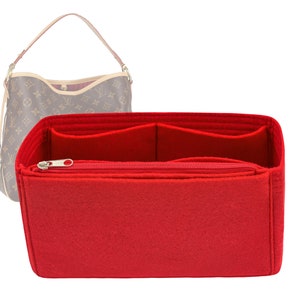 May include: Red felt bag organiser with multiple compartments and a zipped pocket. The organiser is designed to fit inside a handbag.