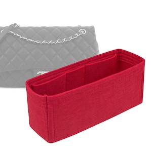 May include: Red felt bag organizer with multiple compartments for a handbag.
