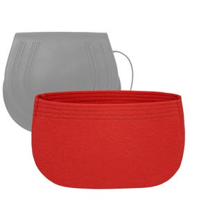 May include: A red felt bag insert for a handbag. The insert is designed to help organize the interior of a handbag.