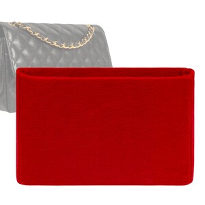 May include: Red felt bag insert for a handbag. The insert is rectangular and has a smooth, even surface.