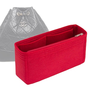 May include: Red felt bag organizer with a zipper closure and two interior compartments. The organizer is designed to fit inside a luxury handbag.