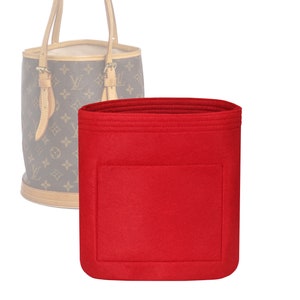 May include: Red felt bag organizer with a large pocket. The organizer is designed to fit inside a handbag.