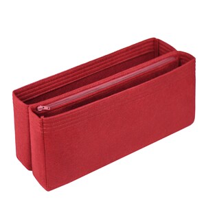 May include: Red felt bag organizer with a zippered compartment. The organizer has multiple compartments and is designed to fit inside a larger bag.