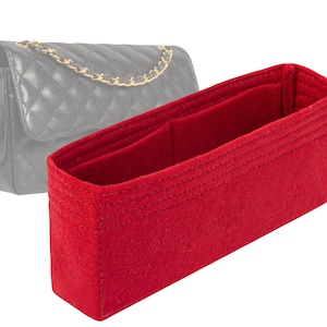 May include: Red felt bag insert for a handbag. The insert has multiple compartments and is designed to help organize the interior of a handbag.