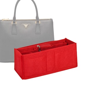 Könnte beinhalten: Rote Filztasche Organizer mit mehreren Fächern für eine Handtasche. Der Organizer hat einen Reißverschluss und ist so konzipiert, dass er in eine größere Tasche passt.
