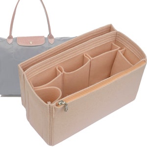 May include: A light gray tote bag with pink leather accents and a beige felt bag organizer. The organizer has multiple compartments and a zippered closure, designed to fit inside the tote bag.