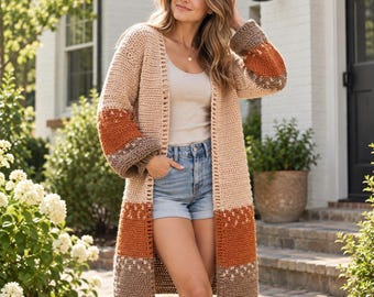 May include: A long-sleeved, open-front crochet cardigan featuring a color-blocked design in shades of beige, burnt orange, and dark brown. The garment has a textured stitch pattern with horizontal stripes and a subtle geometric detail near the cuffs.